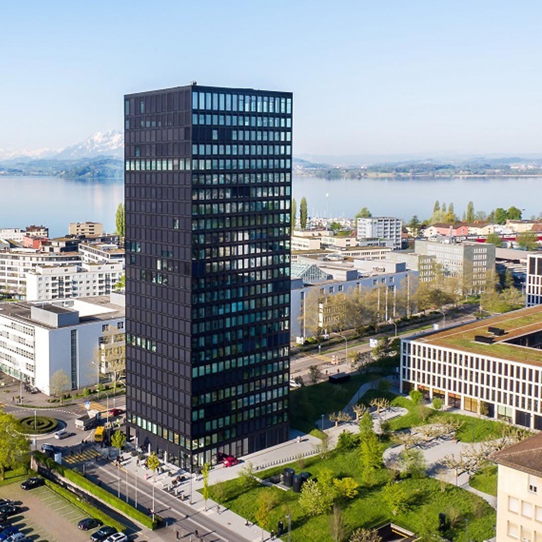 Luftaufnahme des Standorts Zug mit Hochhaus, Stadt und Zugersee – Nähe zum Neubauprojekt Colin.